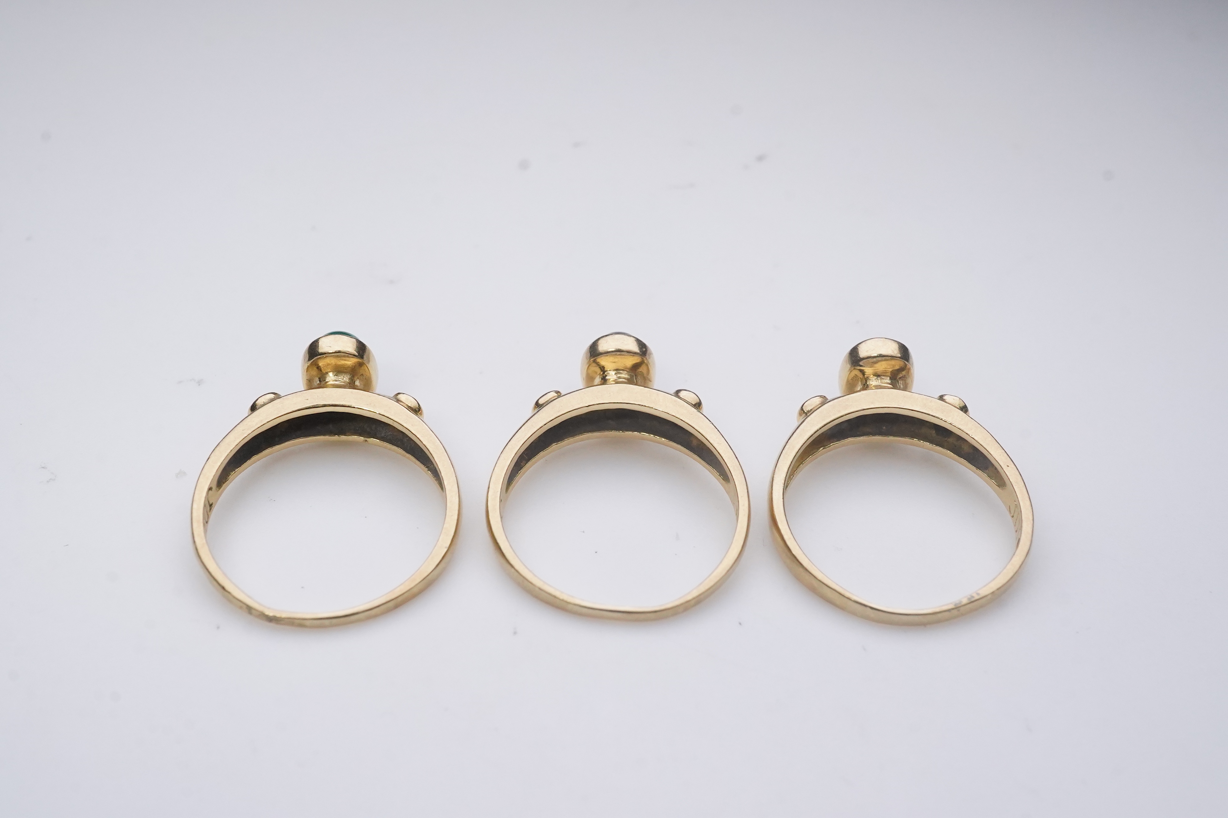 A suite of three gold and gem-set rings